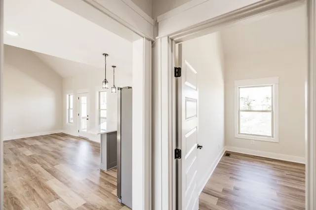 a view of a house with a small yard and wooden floor and fence