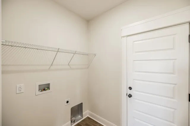 an empty room with staircase and white walls