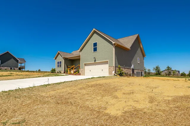 a view of front door of house with wooden stairs