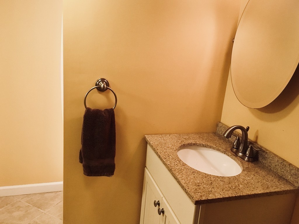 133 Powell Avenue Springfield, MA 01118 - Photo 8 of 15 a bathroom with a granite countertop sink and a mirror