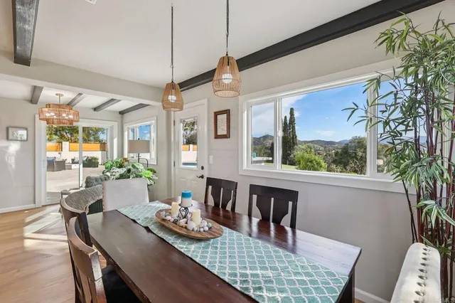 a large kitchen with cabinets a counter and chairs