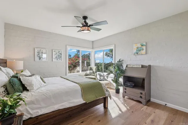 a bedroom with a bed potted plant and a window