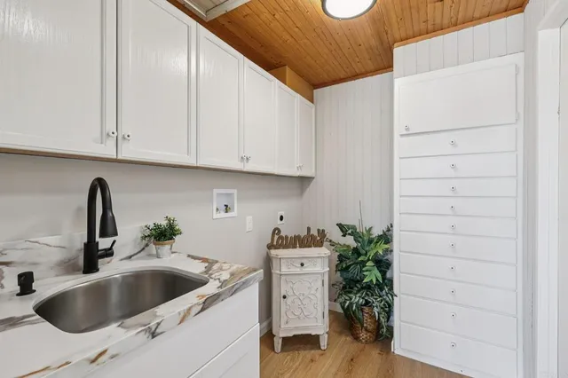 a bathroom with a sink a toilet and shower curtain