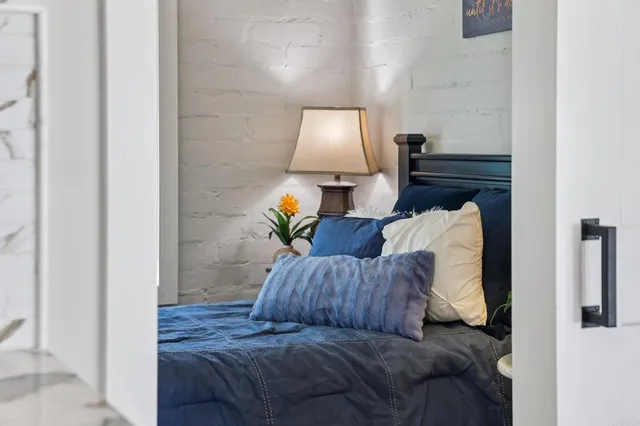 a spacious bedroom with a bed and a chandelier