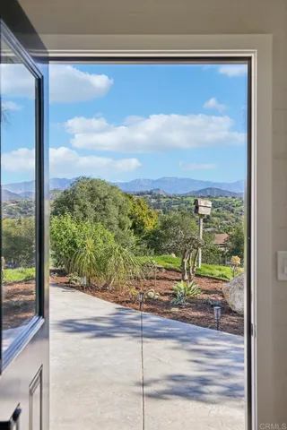 an aerial view of a house with a garden and lake view