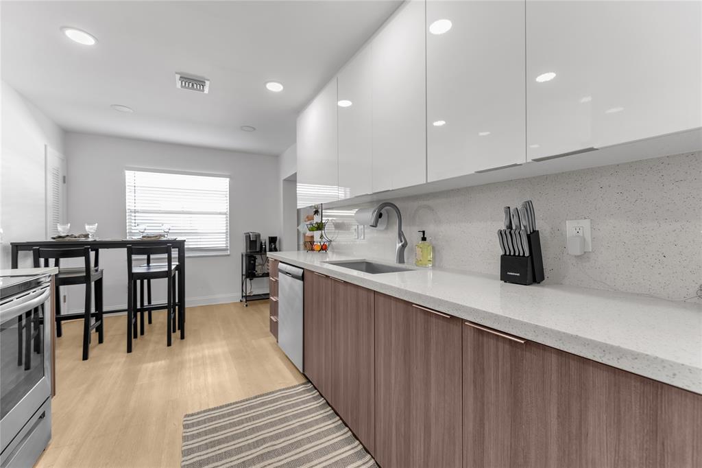 22718 Southwest 65th Terrace Boca Raton, FL 33428 - Photo 12 of 37 a kitchen with stainless steel appliances a sink a stove and a refrigerator