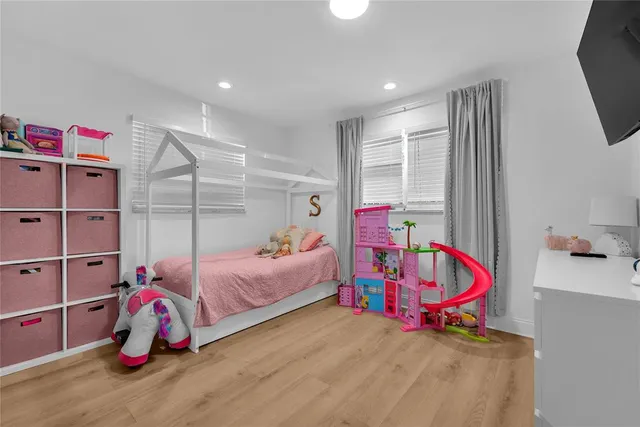 a bedroom with bed and a window