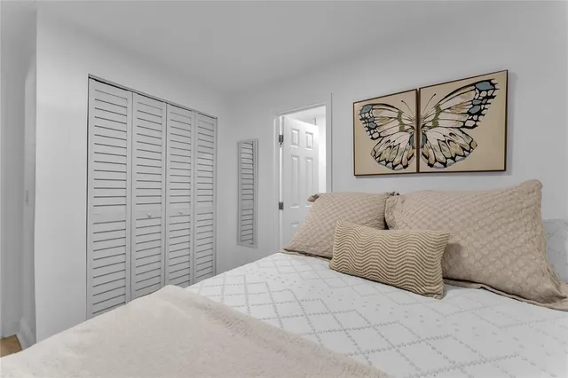 a bedroom with a bed and a wall painting