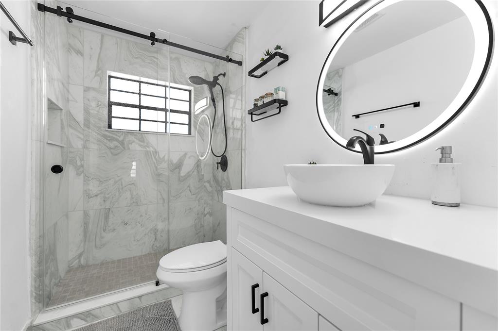 22718 Southwest 65th Terrace Boca Raton, FL 33428 - Photo 15 of 37 a bathroom with a sink a toilet and shower