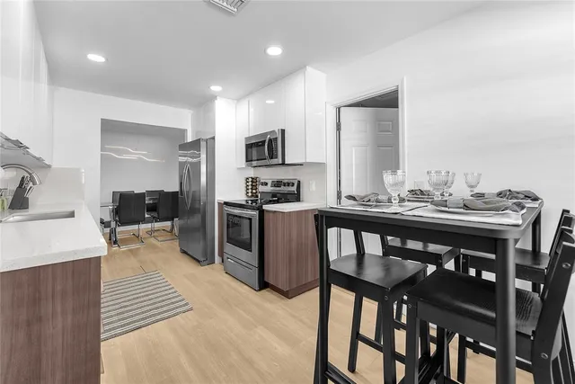 a kitchen with stainless steel appliances a stove a microwave sink and cabinets