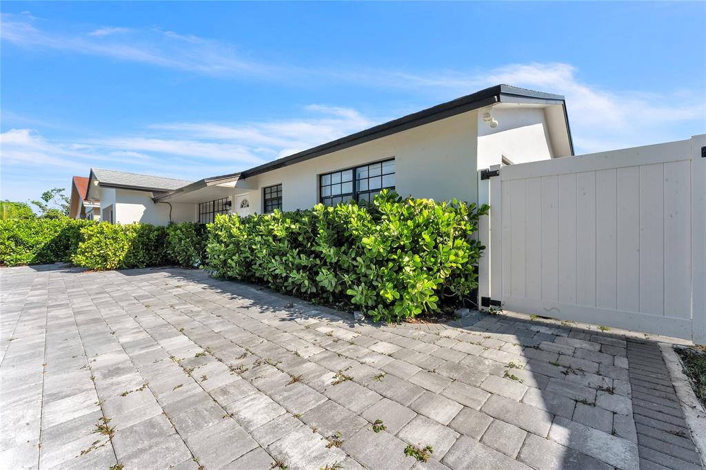 22718 Southwest 65th Terrace Boca Raton, FL 33428 - Photo 21 of 37 a front view of a house with garden