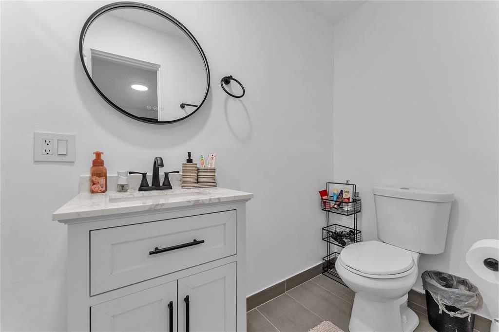 22718 Southwest 65th Terrace Boca Raton, FL 33428 - Photo 26 of 37 a bathroom with a toilet a sink and mirror