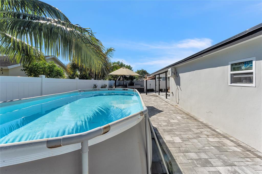 22718 Southwest 65th Terrace Boca Raton, FL 33428 - Photo 33 of 37 a view of swimming pool with a yard