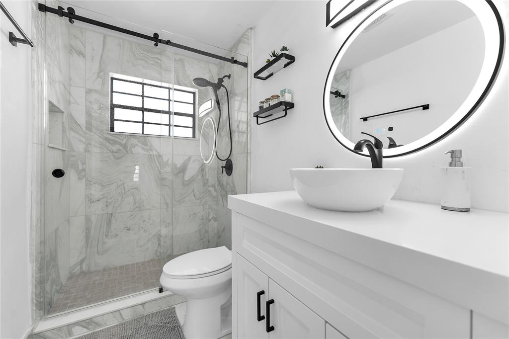 22718 Southwest 65th Terrace Boca Raton, FL 33428 - Photo 34 of 37 a bathroom with a sink a toilet and shower