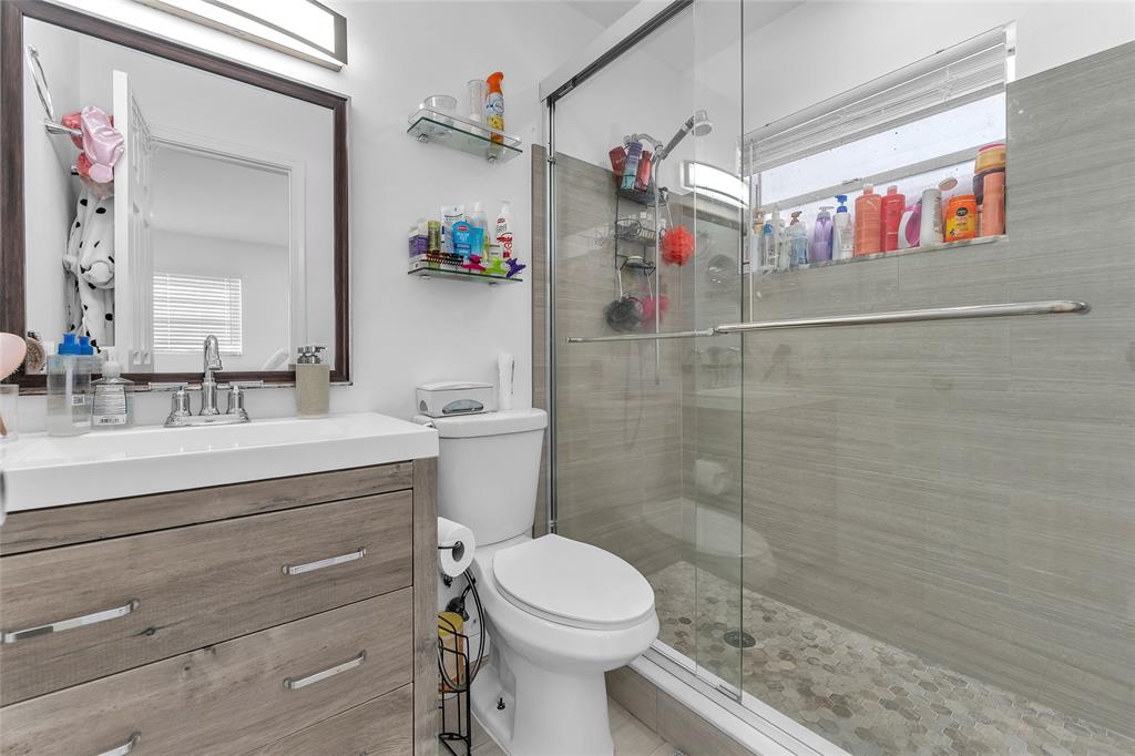 22718 Southwest 65th Terrace Boca Raton, FL 33428 - Photo 37 of 37 a bathroom with a sink a toilet and shower