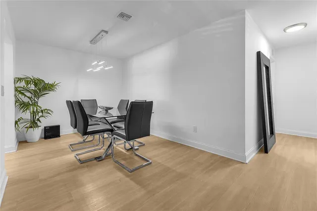 a view of a workspace with furniture and a potted plant