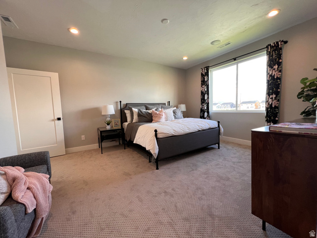 1951 2900 West Provo, UT 84601 - Photo 12 of 21 Spacious bedroom featuring light neutral wall paint and a large window with black floral drapes