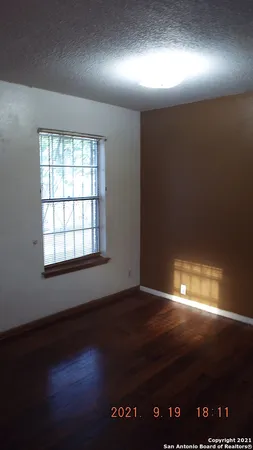 an empty room with wooden floor