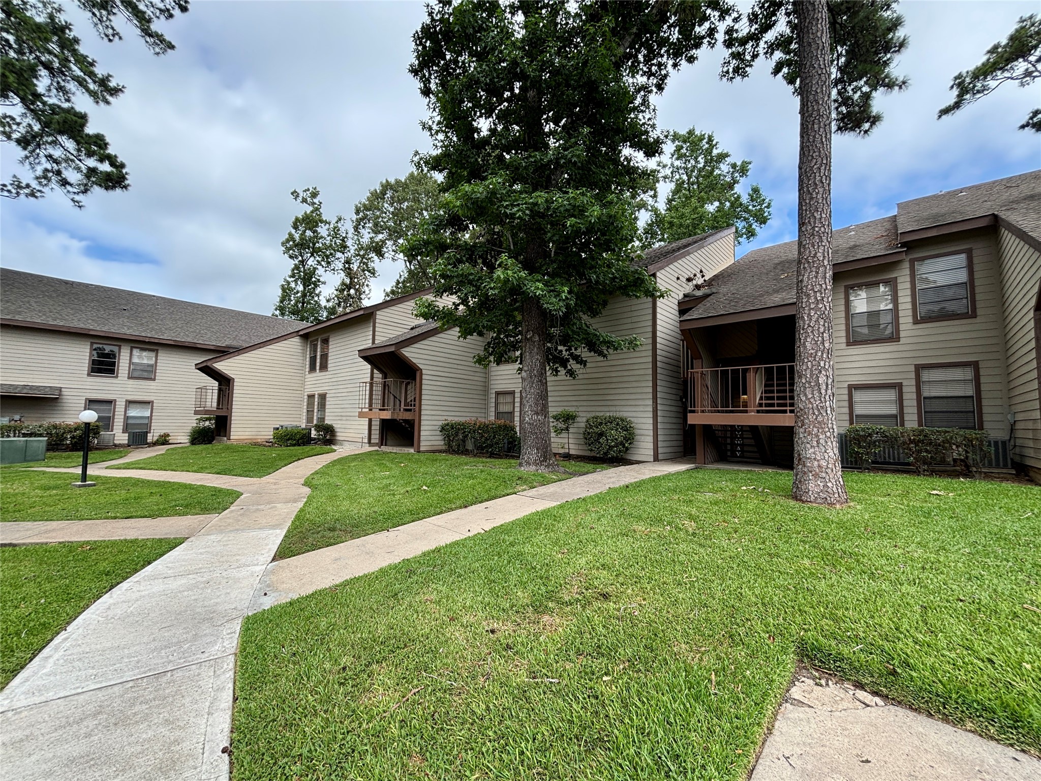 12900 Walden Road, Unit 508E Montgomery, TX 77356 - Photo 21 of 25 a front view of a house with a yard and garage