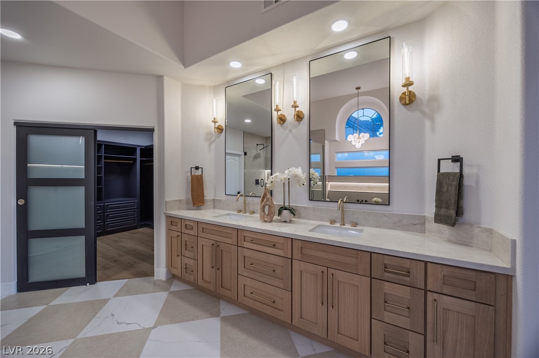 8800 Lusso Las Vegas, NV 89134 - Photo 45 of 85 Full bathroom with double vanity, a spacious closet, a stall shower, and recessed lighting