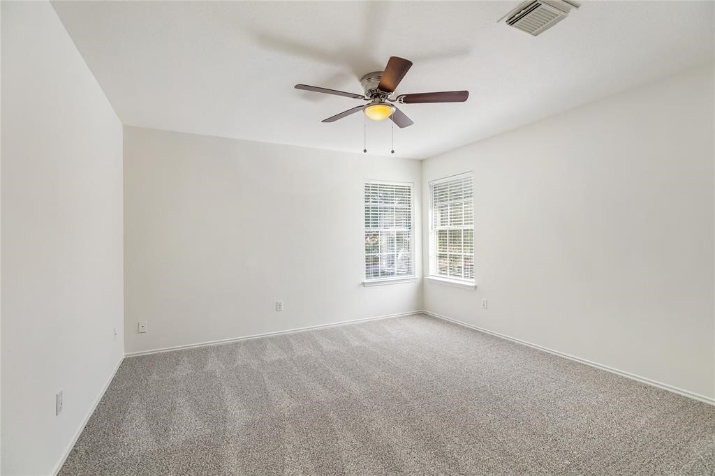 9410 Calwood Circle Spring, TX 77379 - Photo 23 of 34 an empty room with windows and fan