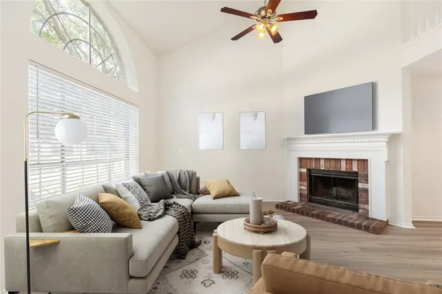 a living room with furniture a fireplace and a chandelier