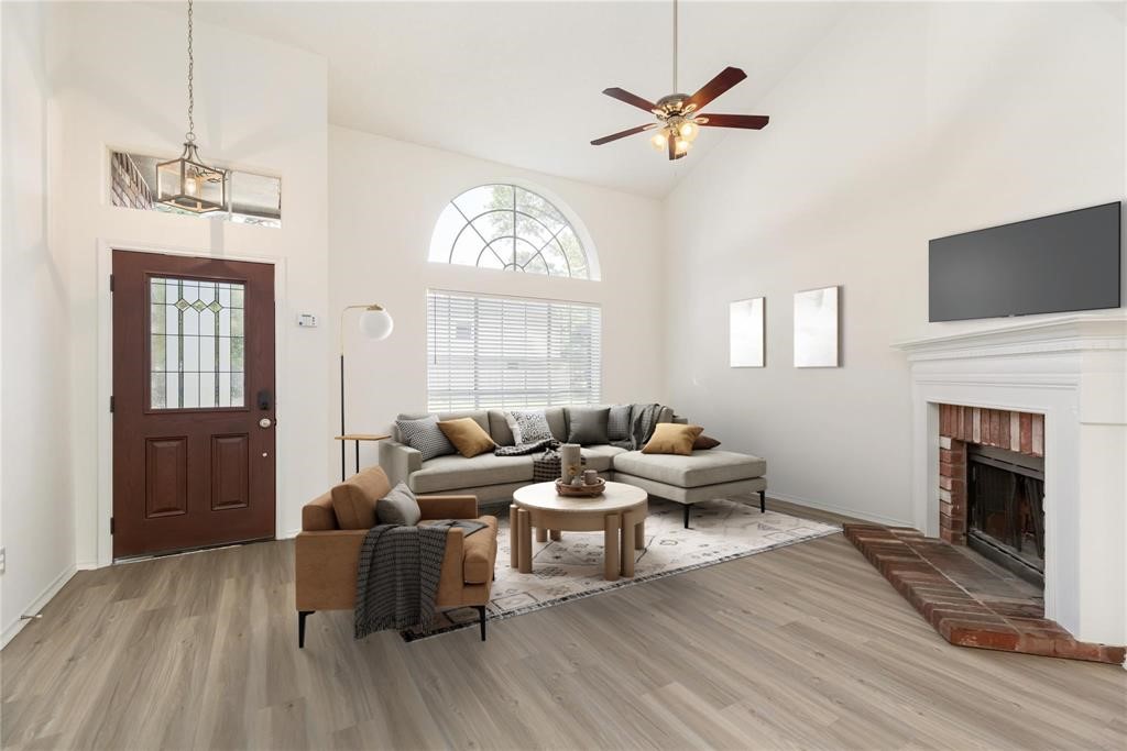 9410 Calwood Circle Spring, TX 77379 - Photo 5 of 34 a living room with furniture a fireplace and a chandelier