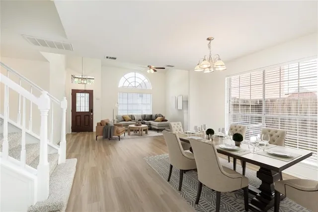 a kitchen with granite countertop white cabinets and stainless steel appliances