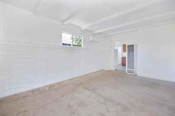 a view of an empty room and a window