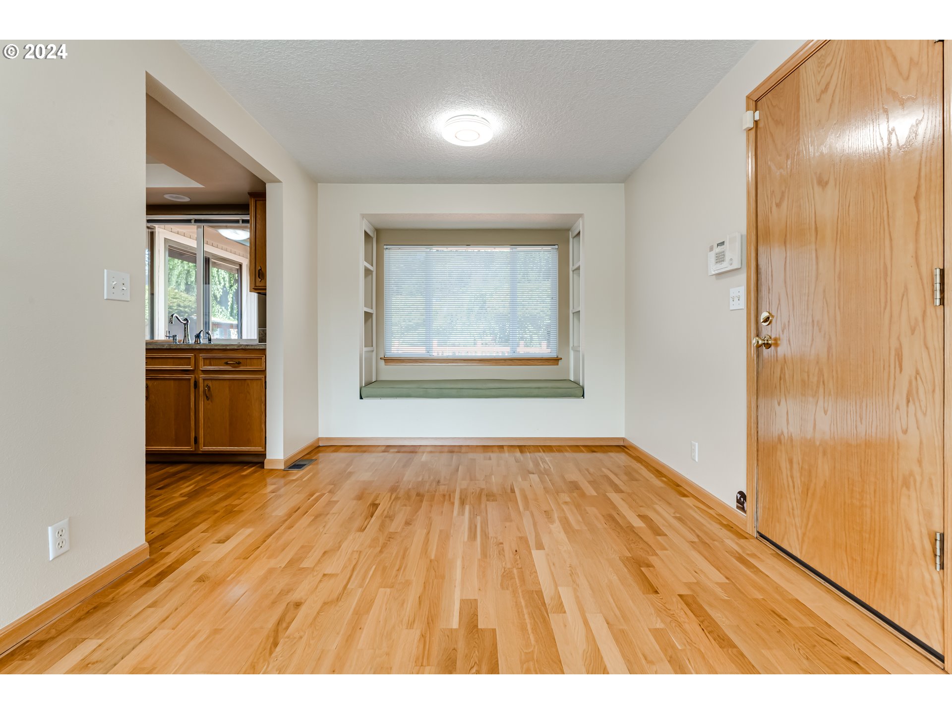 530 66th Street Springfield, OR 97478 - Photo 8 of 36 an empty room with wooden floor and windows