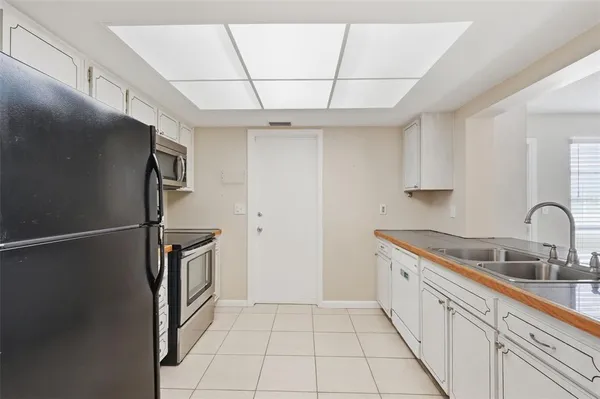 a kitchen with sink and mirror