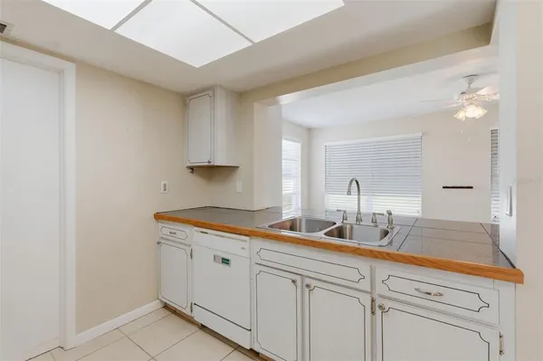 a kitchen with stainless steel appliances white cabinets white stove a microwave and a refrigerator
