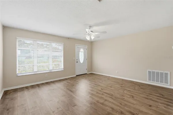 wooden floor in an empty room with a window