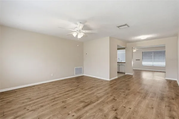 an empty room with wooden floor and cabinet