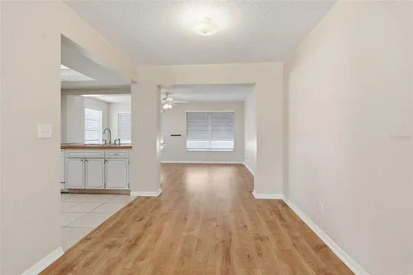 a view of a room with wooden floor and a window