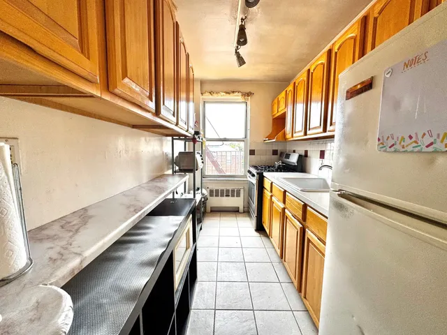 a view of a kitchen with a sink and cabinets