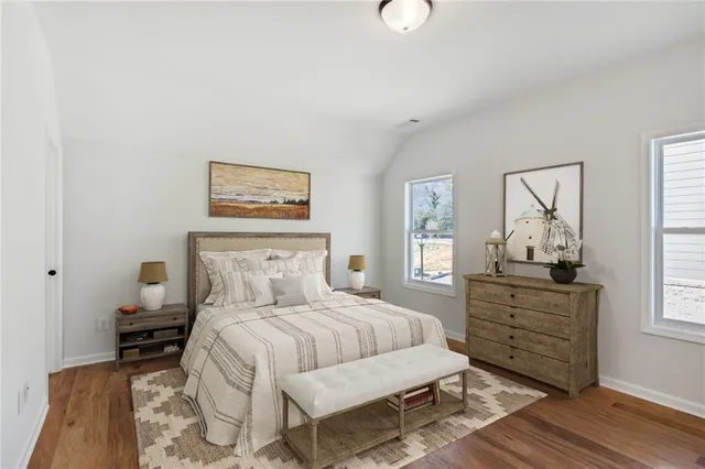 a bedroom with a bed and wooden floor