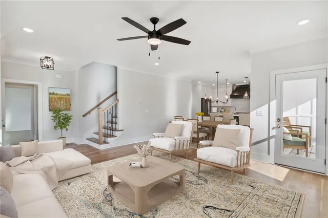 a living room with furniture a rug and a chandelier
