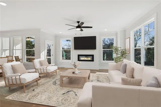 a living room with furniture a fireplace and a flat screen tv