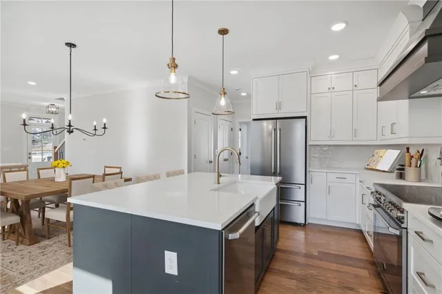 a kitchen that has a lot of cabinets a sink and a refrigerator
