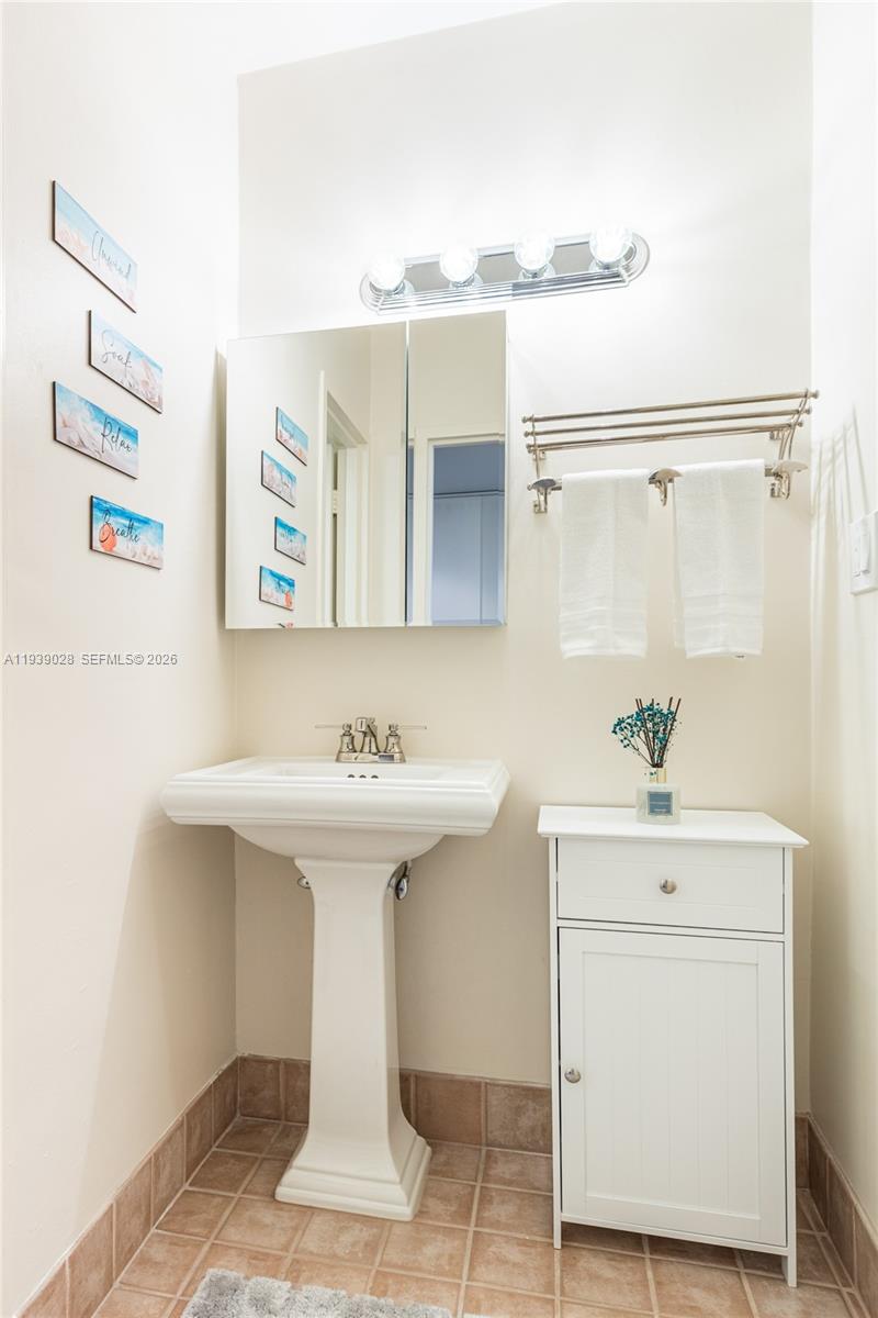 100 Lincoln Road, Unit 431 Miami Beach, FL 33139 - Photo 23 of 34 a bathroom with a sink a mirror and a shower