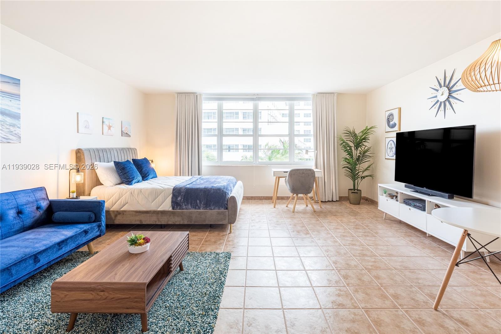 100 Lincoln Road, Unit 431 Miami Beach, FL 33139 - Photo 5 of 34 a living room with furniture and a flat screen tv