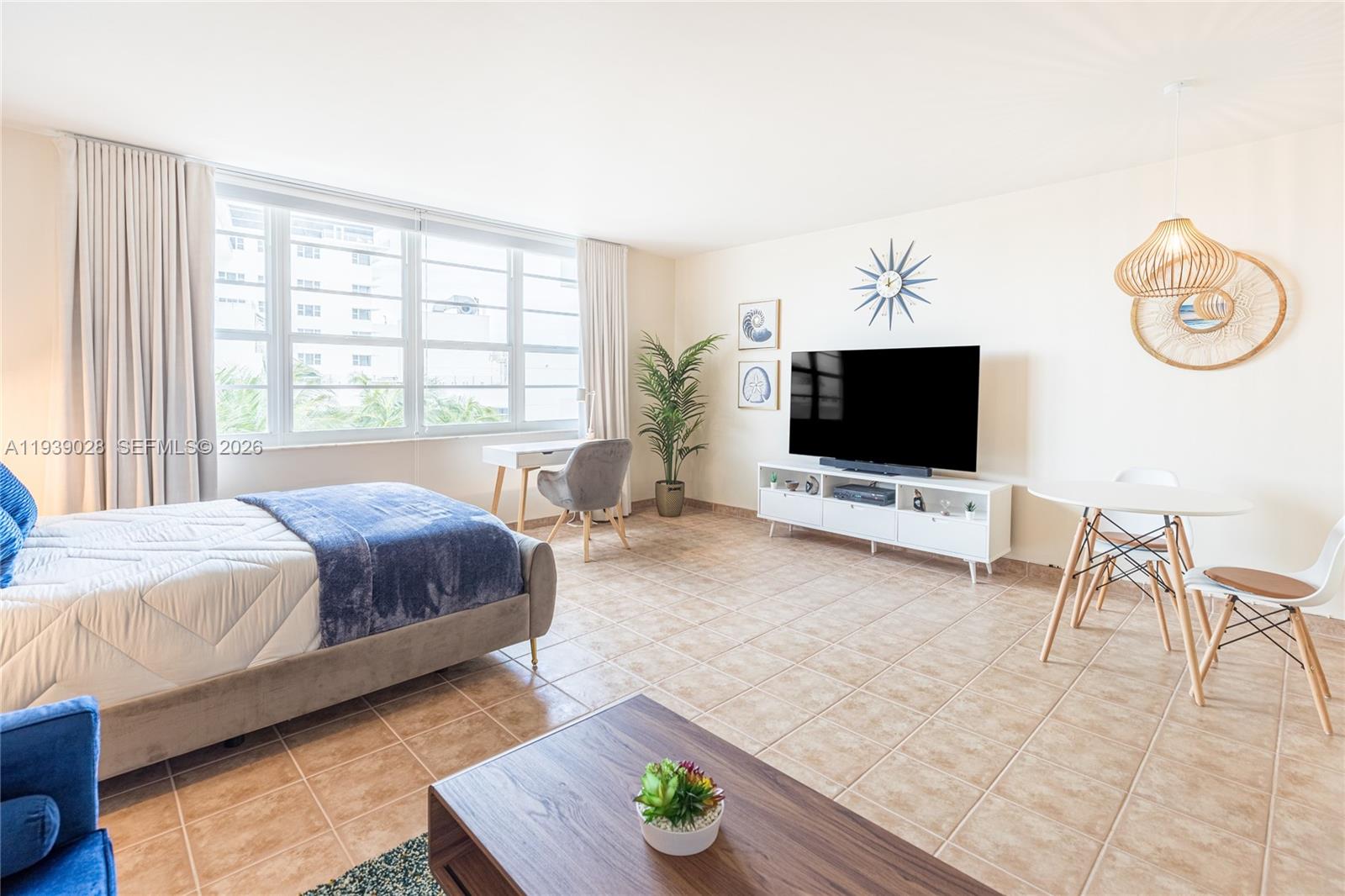 100 Lincoln Road, Unit 431 Miami Beach, FL 33139 - Photo 8 of 34 a spacious bedroom with a bed and a flat screen tv