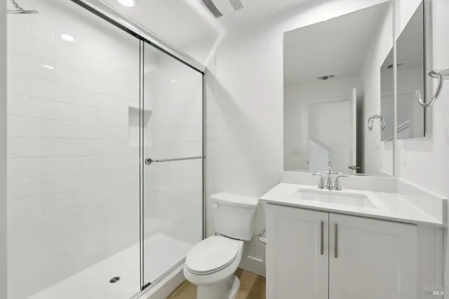 a bathroom with a sink toilet and shower