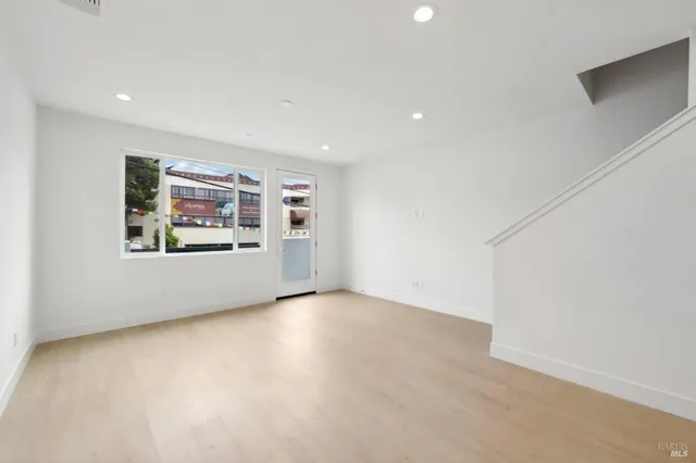 an empty room with windows and cabinet