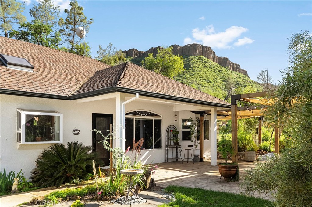 2262 Honey Run Road Chico, CA 95928 - Photo 1 of 74 Tucked along the coveted Honey Run Road, just 1.5 miles from the newly rebuilt iconic Honey Run Covered Bridge, this beautifully designed 3-bedroom, 2-bath home offers 1,958 square feet of thoughtfully curated living space on 3.97 acres. Built in 2002, this property blends comfort, creativity, and functionality in a truly one-of-a-kind setting. As you arrive, you’re welcomed by a striking cactus garden in the front of the home. Just beyond, the outdoor entertaining area features a custom pizza oven and f...