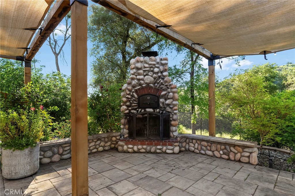 2262 Honey Run Road Chico, CA 95928 - Photo 3 of 74 Just beyond, the outdoor entertaining area features a custom pizza oven and fireplace—perfect for gathering year-round—while taking in views of Castle Rock.
