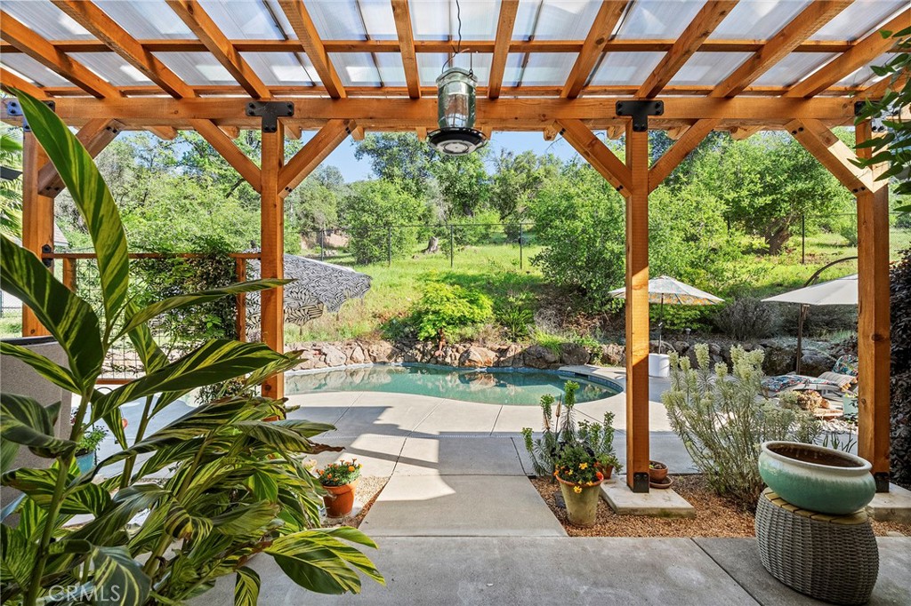 2262 Honey Run Road Chico, CA 95928 - Photo 4 of 74 artistic and truly one-of-a-kind feature—while passing lush landscaping and raised garden beds. The backyard is a private retreat designed for both relaxation and entertaining. Enjoy a newer custom covered patio overlooking the salt water pool, along with a separate hot tub for year-round use.