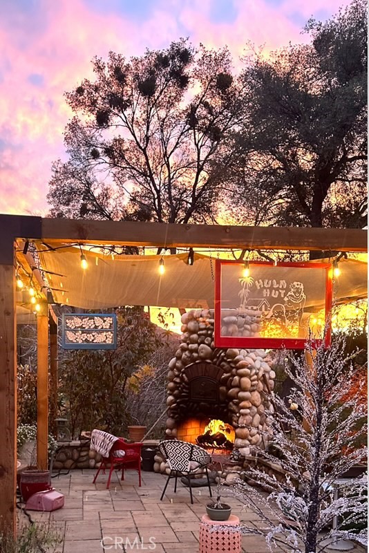 2262 Honey Run Road Chico, CA 95928 - Photo 71 of 74 Provided by Seller at Sunset with cozy fire in outdoor fireplace on front patio.