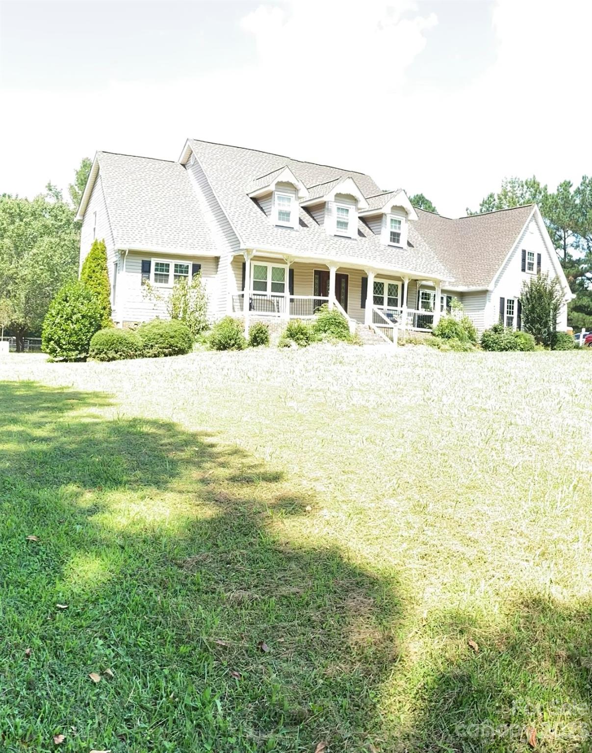461 Potter Road Lancaster, SC 29720 - Photo 1 of 2 a front view of a house with a garden and lake view